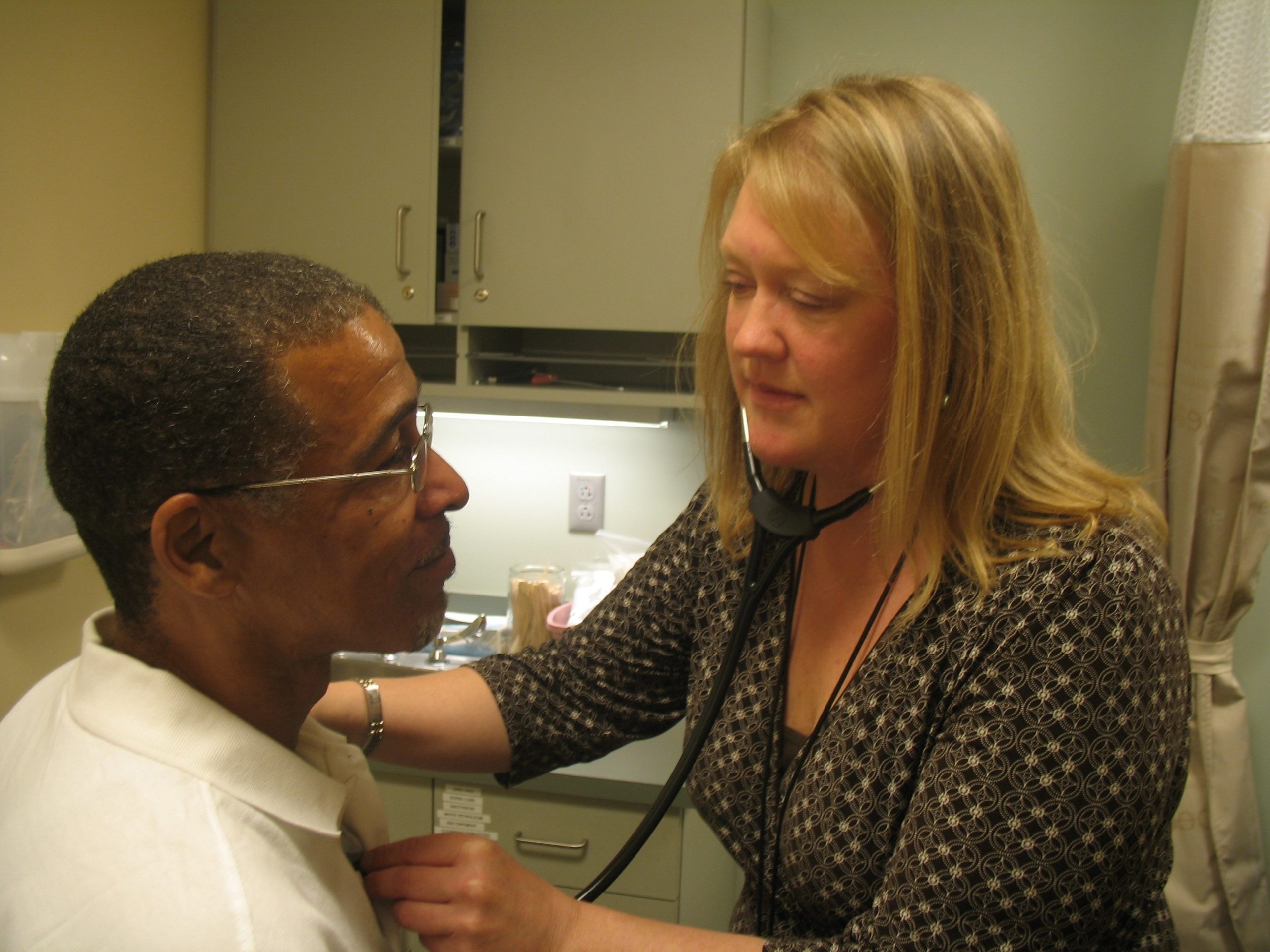 Melinda Thomas checking the vitals of a patient