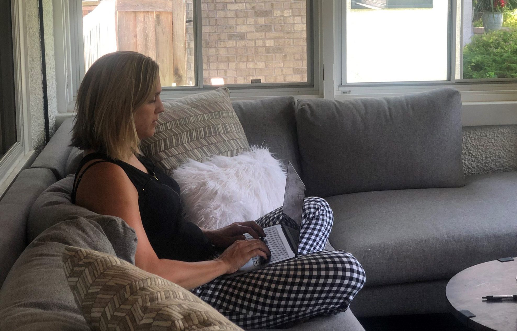 Rachael Jarman using her laptop on the couch