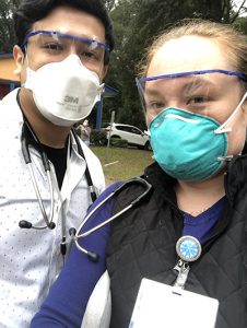 Sebastian Cuitiva, PA-S, left, and Elise Carney, PA-S, right, volunteering at the EAC